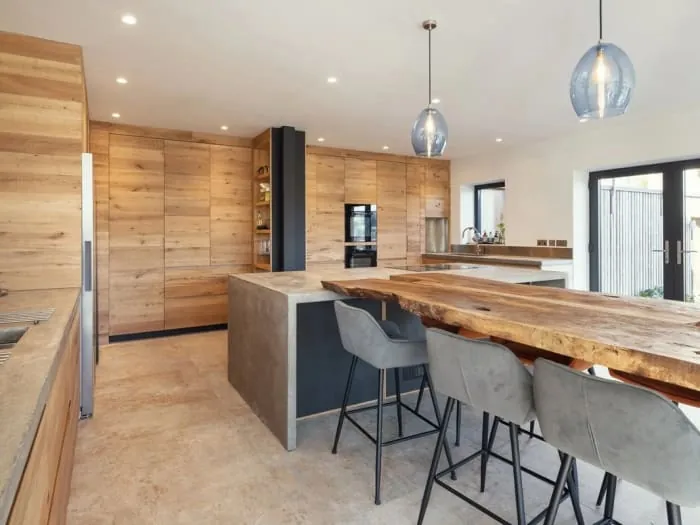 Bespoke oak kitchen with an island and breakfast bar seating