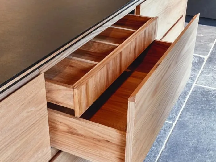 Solid timber drawer box pulled open in a bespoke kitchen cabinet