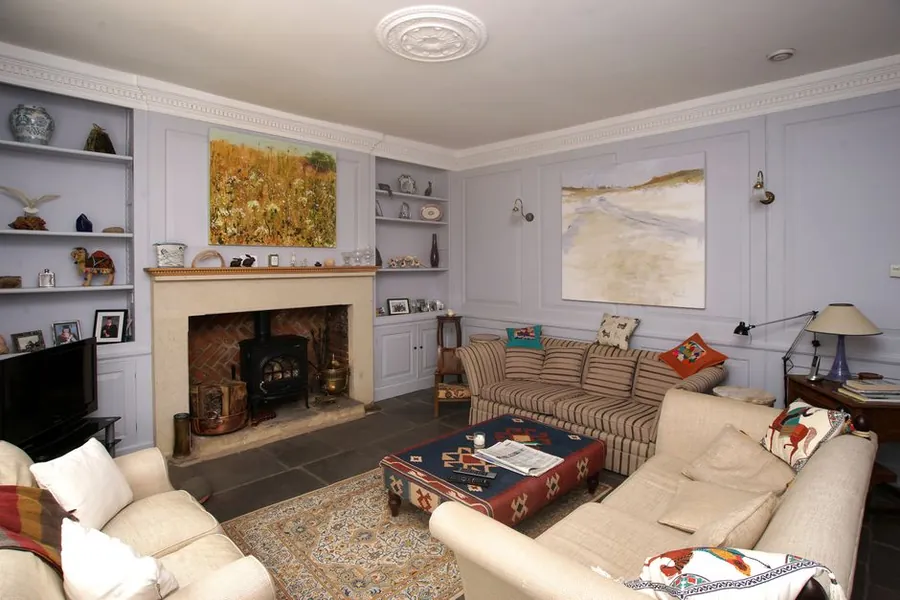 Alcove shelving built either side of a period fireplace, the layout most Torquay home offices are fitted into