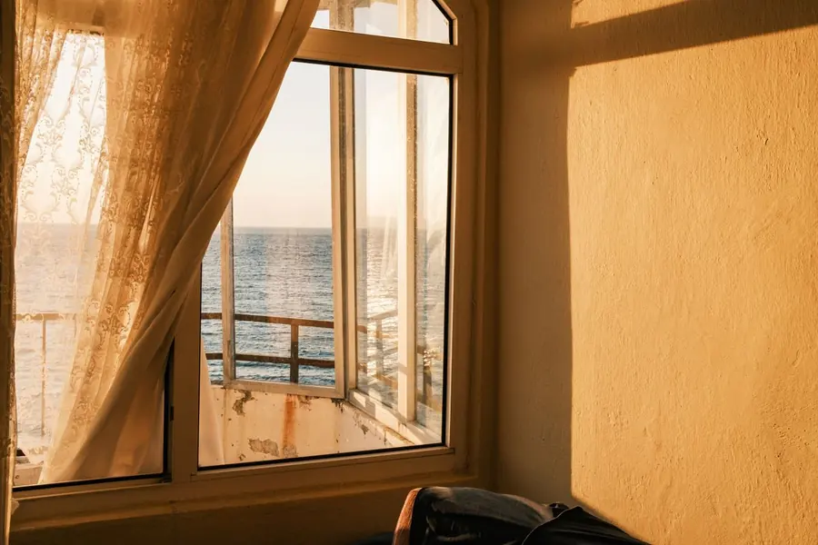 Strong seaside light falling through a window, the kind of brightness that shifts timber colour in Torquay rooms