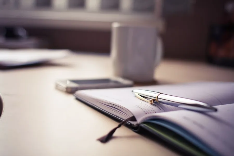 Open planner on a desk, working out when to book a joinery commission