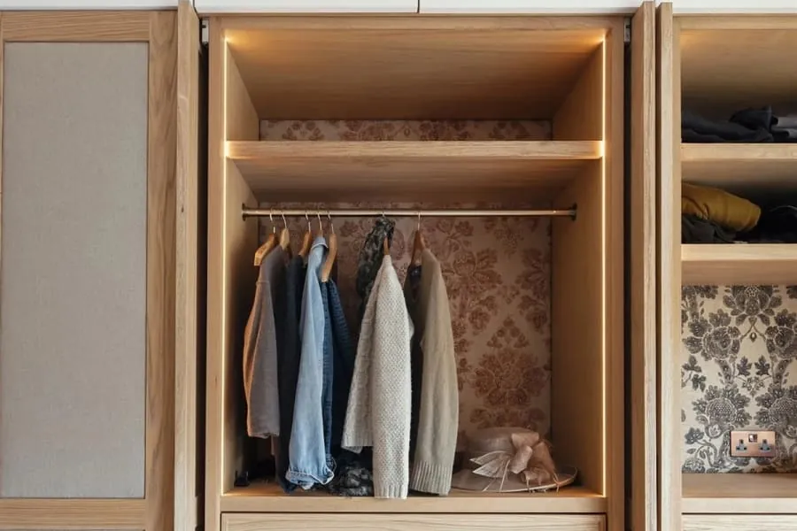 Interior of a fitted unit with hanging rail and drawers made in our Torquay workshop, the construction a boot room run is built from