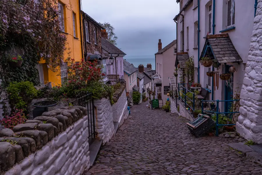 Steep cobbled lane between painted cottages running down towards the sea, the kind of route joinery has to be carried along in Brixham