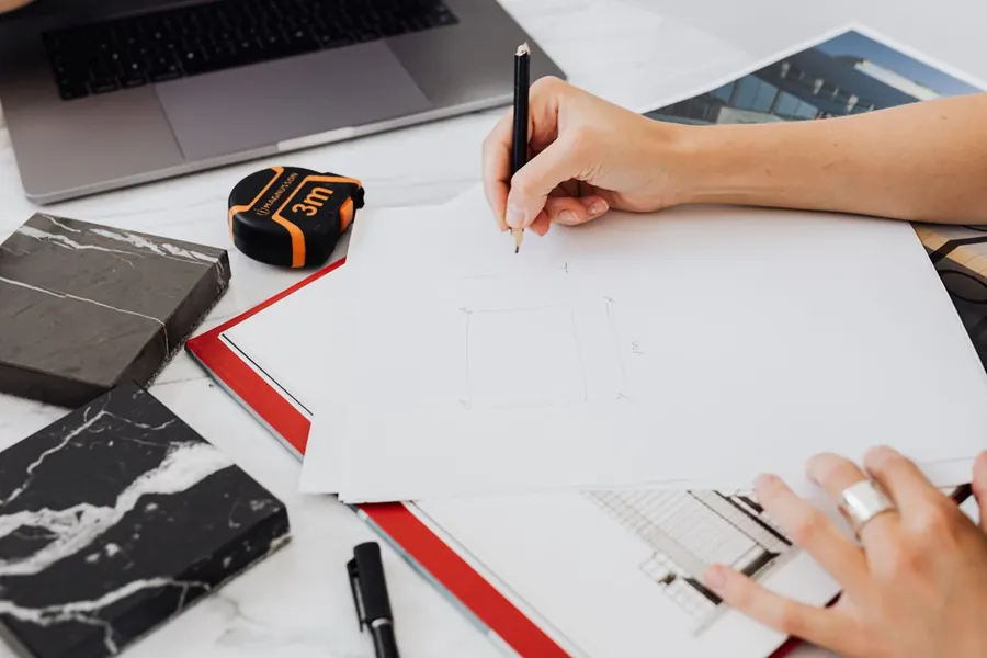 Tape measure and drawings on a desk, working through fitted wardrobe quotes line by line