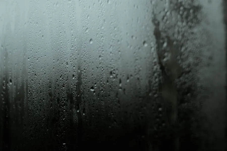 Condensation running down a window pane on a damp morning, the humidity a closed dressing room in a Torbay house has to deal with