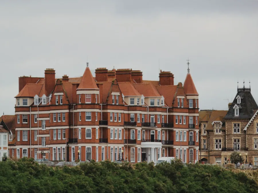 Red-brick Victorian seafront building divided into apartments, the kind of converted block where many Torbay flats need a built-in TV unit