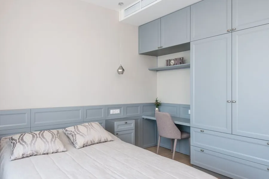Fitted desk built into a run of wardrobes, showing a combined desk-and-storage layout for a home office