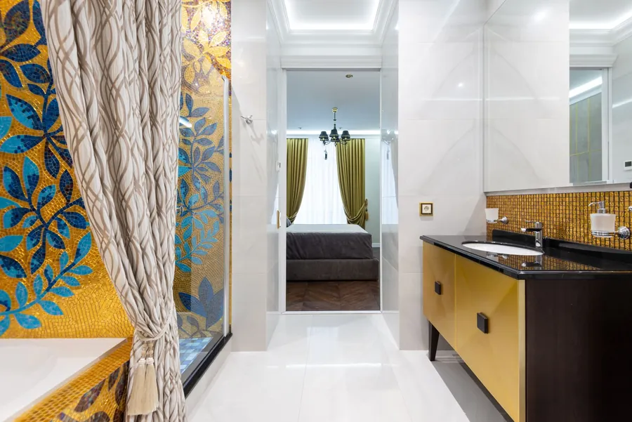 View from a bathroom vanity through a doorway into the bedroom beyond, the bedroom to en-suite route a pass-through dressing room sits on