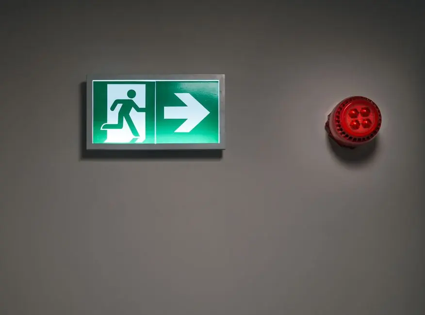 Illuminated fire escape sign and alarm sounder, the fire safety context fitted joinery in a holiday let has to work within