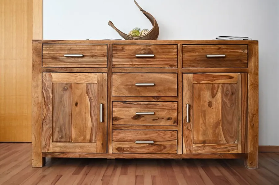 Wooden cabinet doors and handles of the kind that catch when spring humidity rises in Torbay