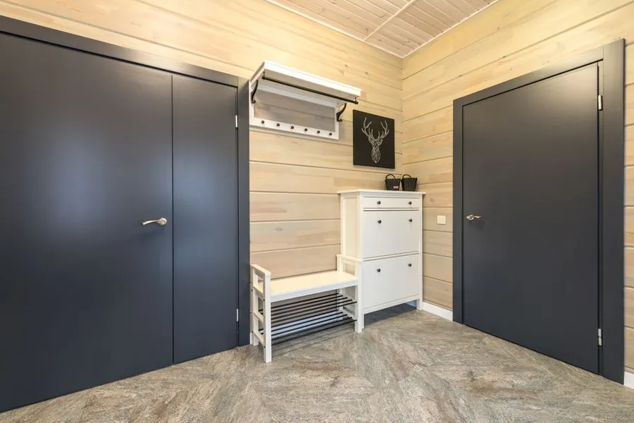 Entrance room with hardwearing floor, fitted cupboards, hooks and a slatted shoe bench, the material mix a Torquay boot room needs