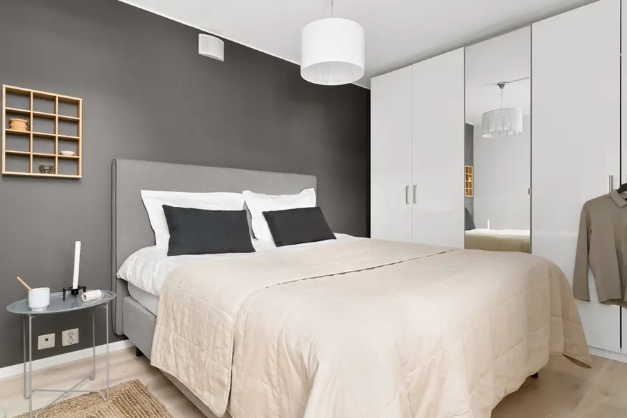 Guest bedroom with floor-to-ceiling fitted wardrobes, the storage depth a holiday let bedroom needs
