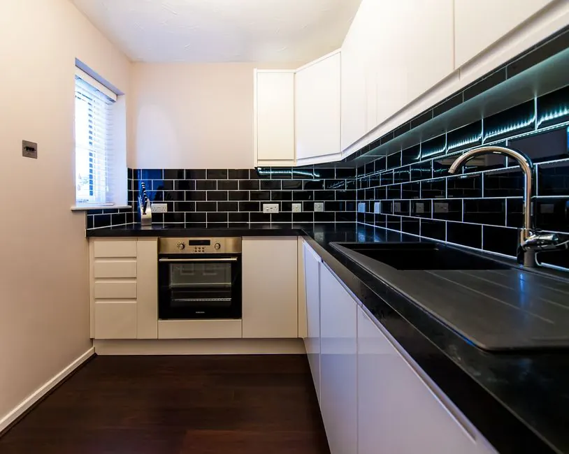 Compact fitted kitchen with integrated appliances, the layout most Torquay holiday let apartments need