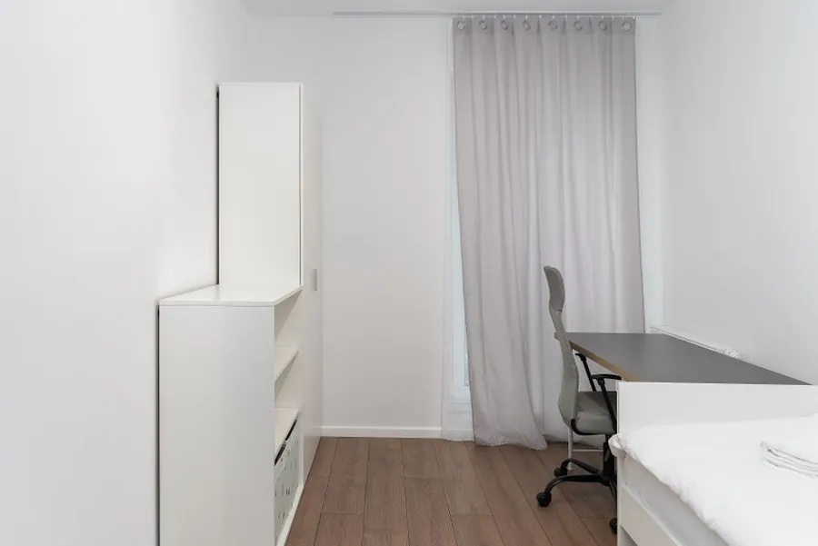 Small bedroom converted into a home office with a fitted desk against the window, the kind of box room common in Torquay terraces
