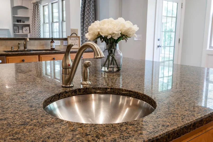Granite worktop with an inset sink in a fitted kitchen, one of the largest single lines in a kitchen quote