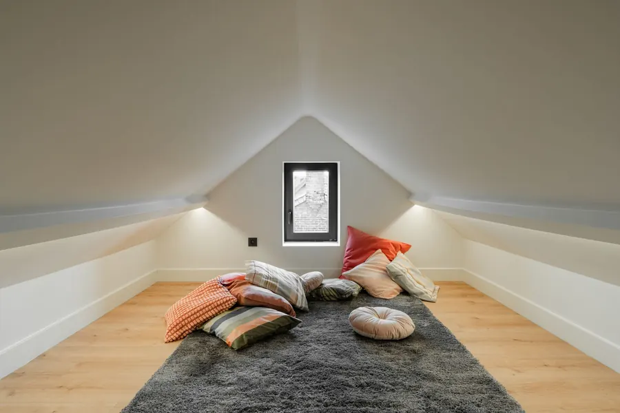 Narrow attic room with long low knee walls on both sides, the kind of eaves run priced per bay for drawers and cupboards in Torbay