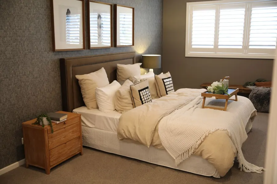White louvred shutters fitted across a bedroom window, the type of shutter we price against factory-made and ready-made options for Torquay homes