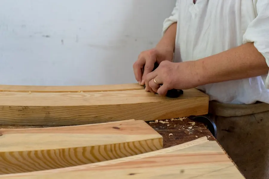 Joiner hand-working a length of softwood at the bench, the starting point for copying a period moulding profile