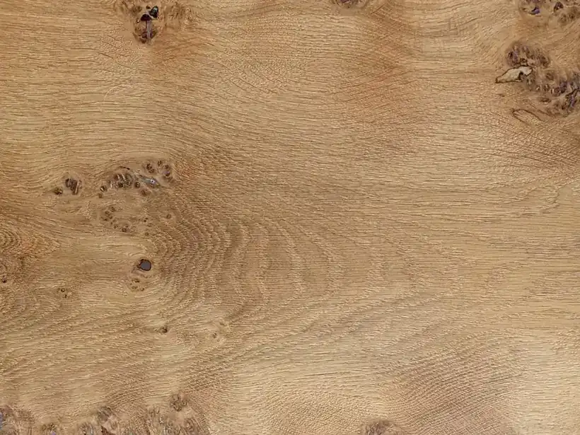 Oak boards showing the knots and grain variation a joiner reads before cutting