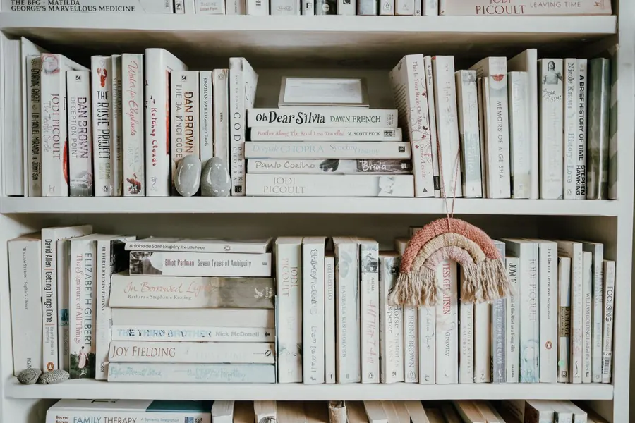 White painted bookcase shelves filled with books, the painted finish most often chosen for period rooms in Torquay