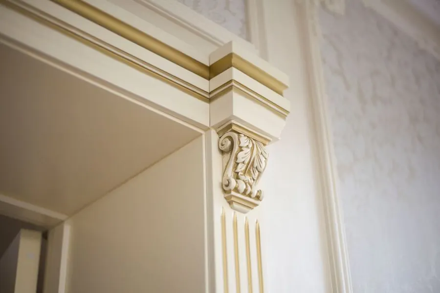 Ornate plaster cornice and pilaster detail in a period room, the standard a matched moulding has to sit alongside