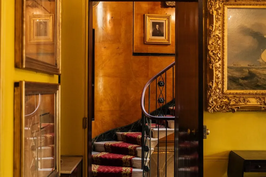 Ornate period staircase and panelled hallway of the kind found in listed Torquay properties