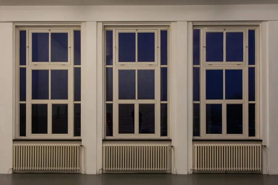 Tall windows with column radiators beneath them, the heating layout a Torquay bay window seat has to be designed around