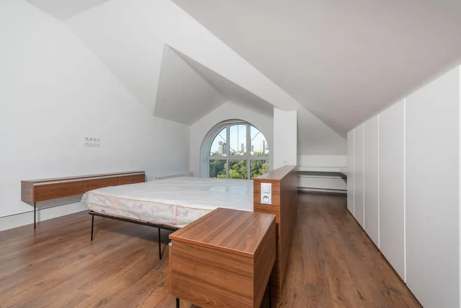 Bedroom in the roof with fitted wardrobes built under the sloping ceiling