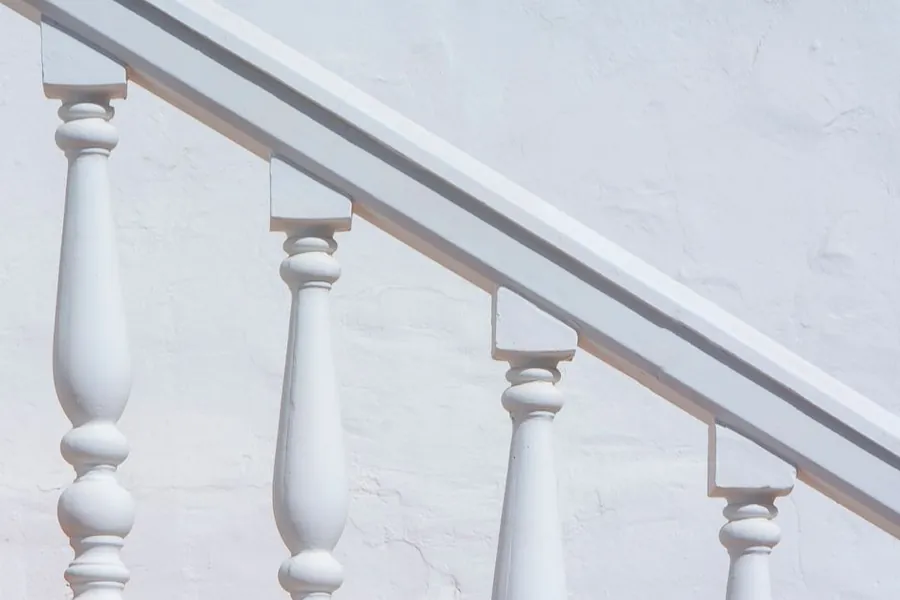 Painted timber balustrade with turned spindles and handrail on a staircase