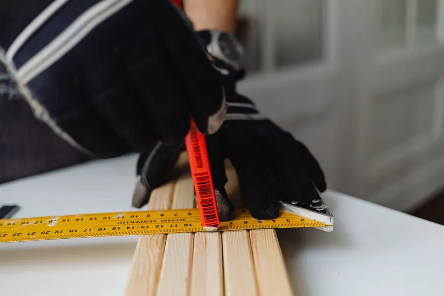 Marking out timber against a square during templating for bespoke joinery in Torquay