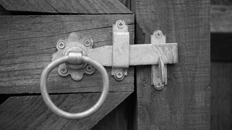 Close detail of a timber garden gate showing brace, ledge and latch construction typical of Torbay side gates