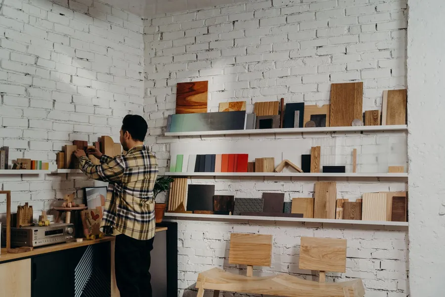 Shelves of timber, painted board and veneer samples in a joinery workshop, the material choices behind Torquay bay joinery