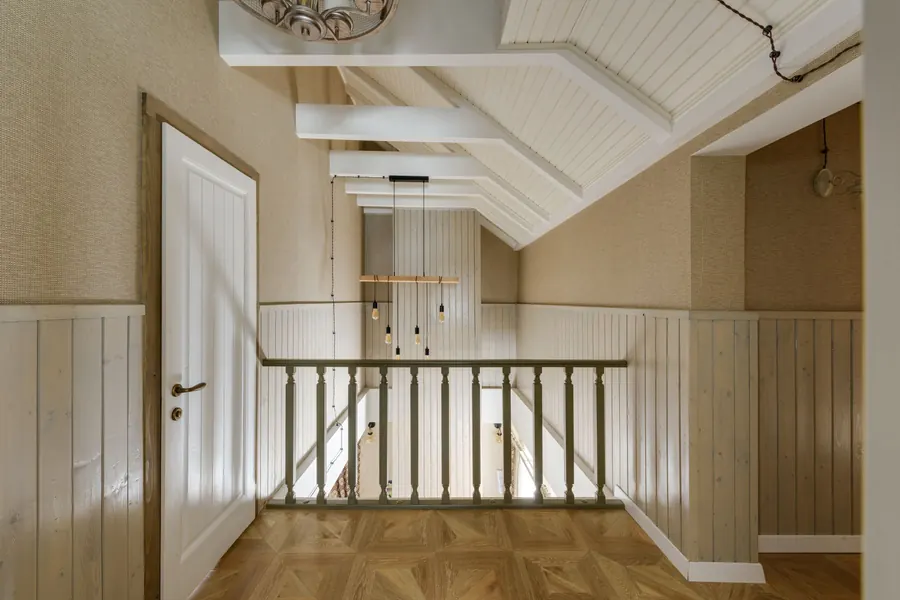 Painted tongue-and-groove wainscot running around a landing and stair balustrade, a hard-wearing panelling choice for Torquay hallways and stairs