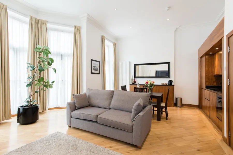 Well-fitted holiday apartment living space with built-in kitchen joinery, the standard a Torbay let competes at