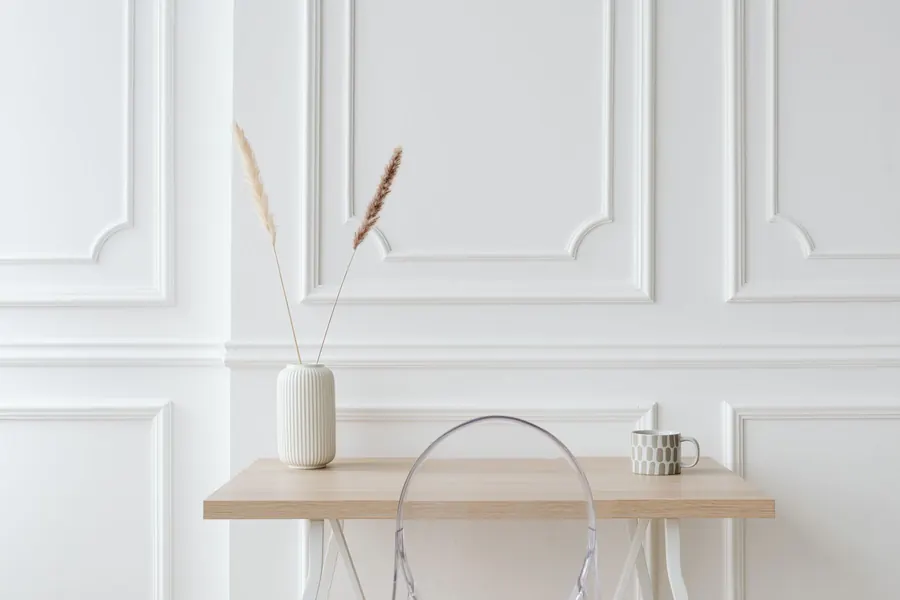 White two-tier box panelling with moulded frames above and below a dado rail, the proportion that suits Torquay's high-ceilinged Victorian villas