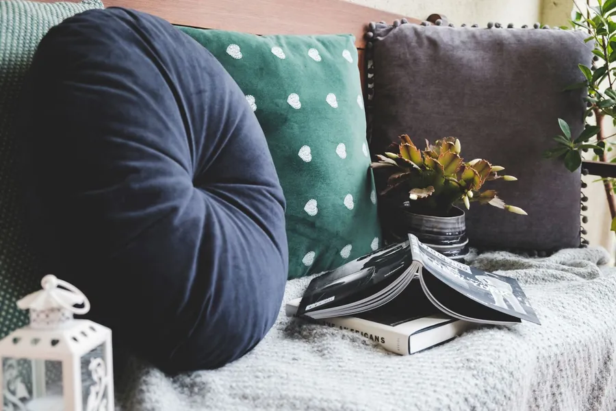 Cushions and a throw on a seat by a window, the cushion specification that finishes a Torquay bay window seat