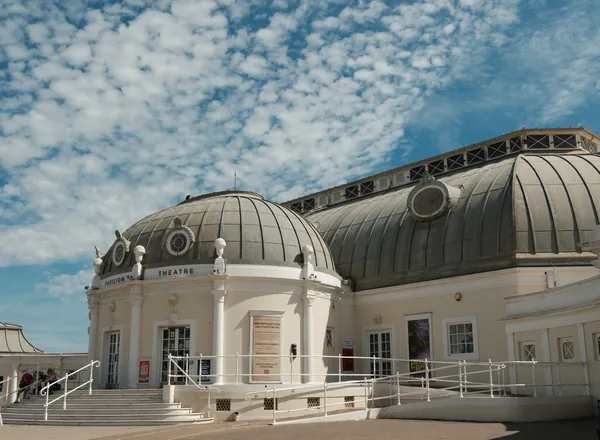 The white domed front of a seaside pavilion theatre under a blue sky