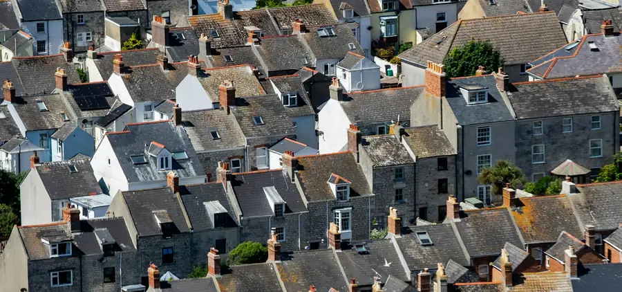 Slate and tile cottage rooftops packed closely together on a hillside