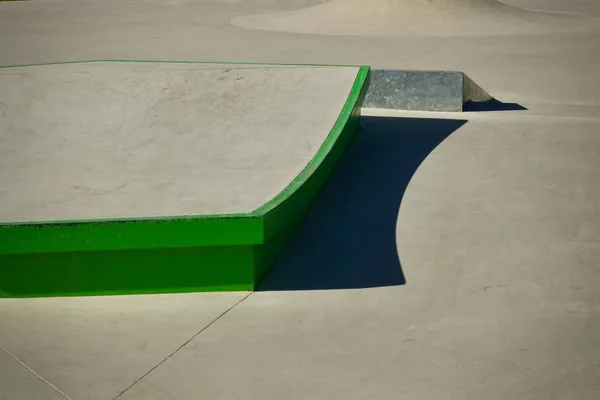 A smooth concrete ramp at an outdoor skate park