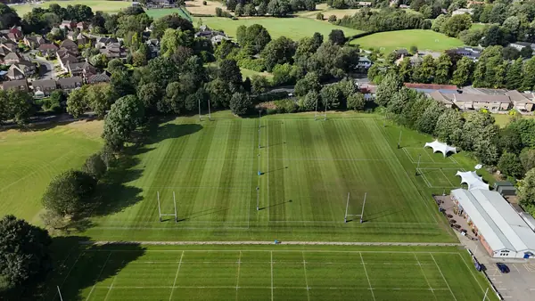 Marked-out sports pitches and green fields seen from above