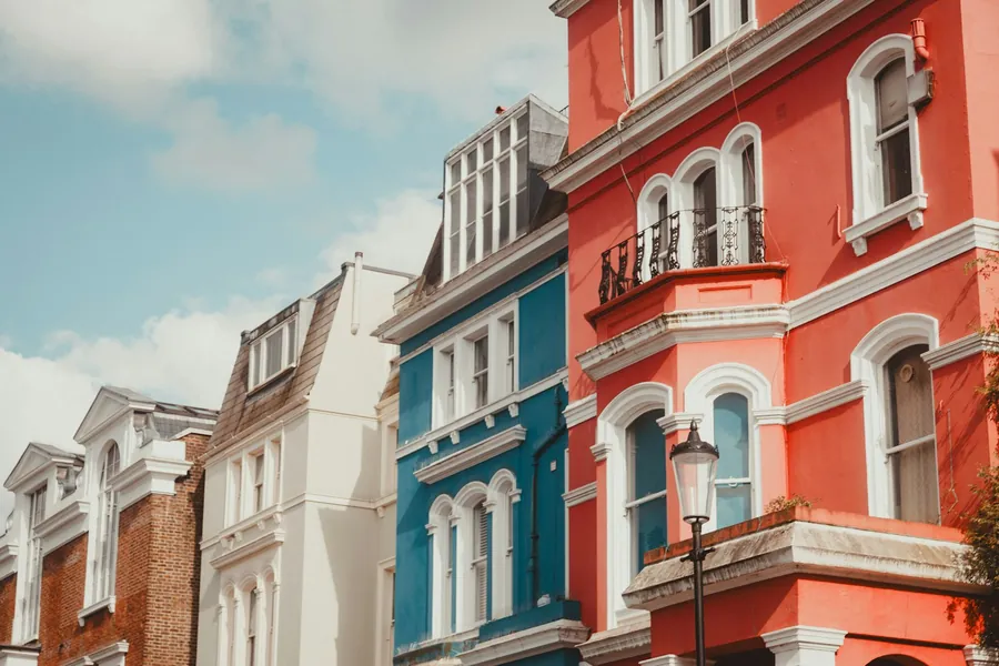 Brightly painted rendered houses with bay windows and white trim
