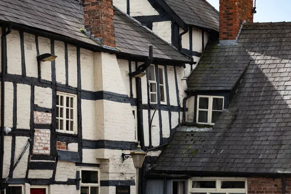 Black and white timber-framed houses with jettied upper floors