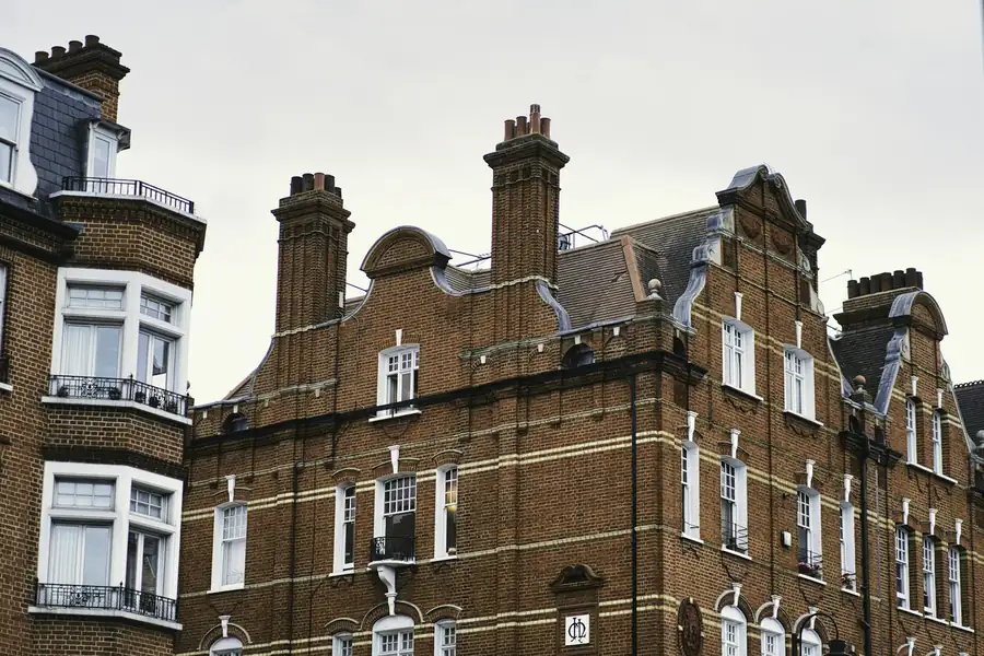 Gabled Victorian brick houses with bay windows and tall chimneys